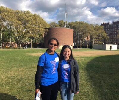 Alice and Janet standing on Killian Court. Maseeh can be seen in the background.