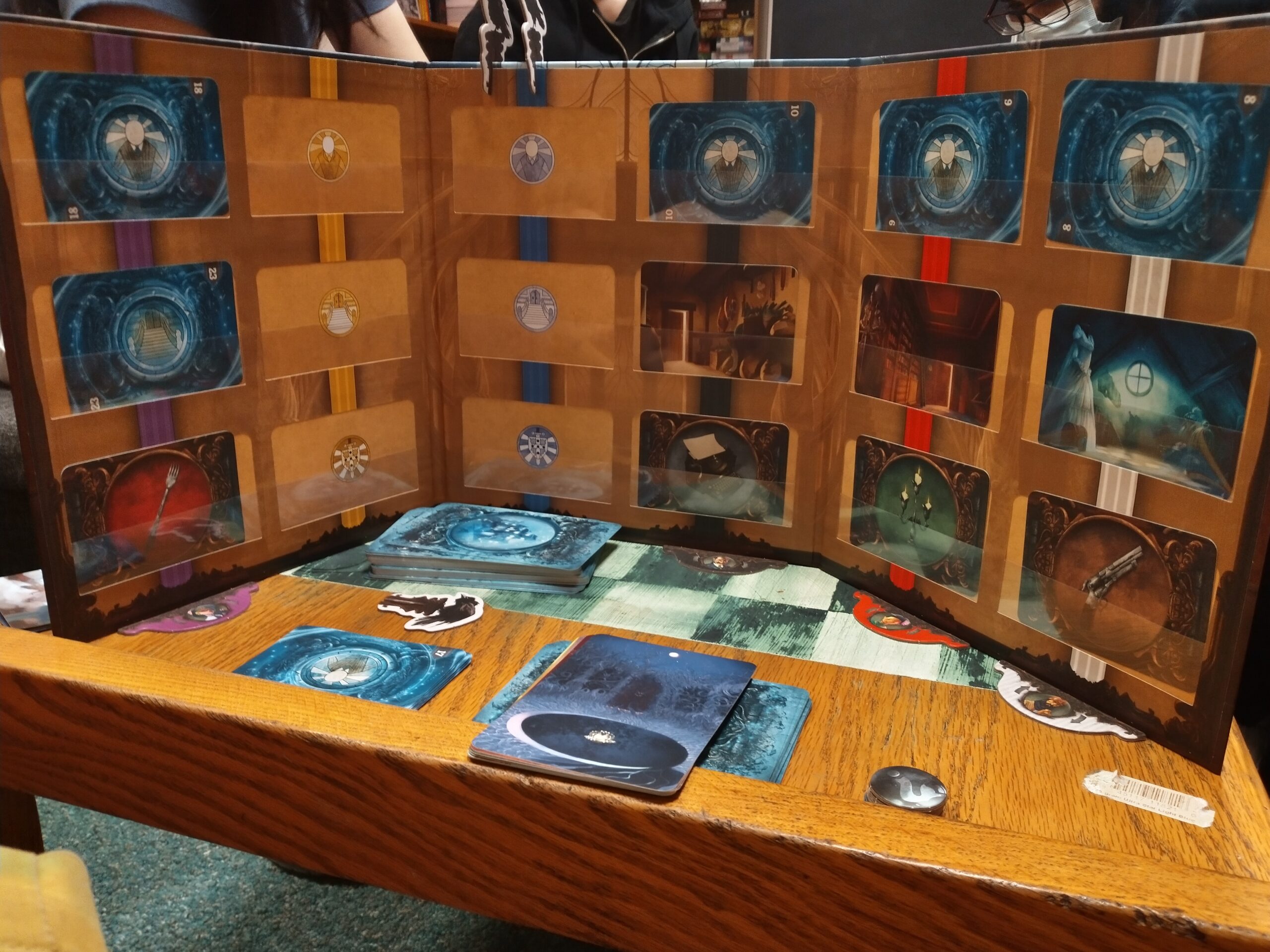a screen from mysterium, facing me, with a bunch of cards slotted in slots