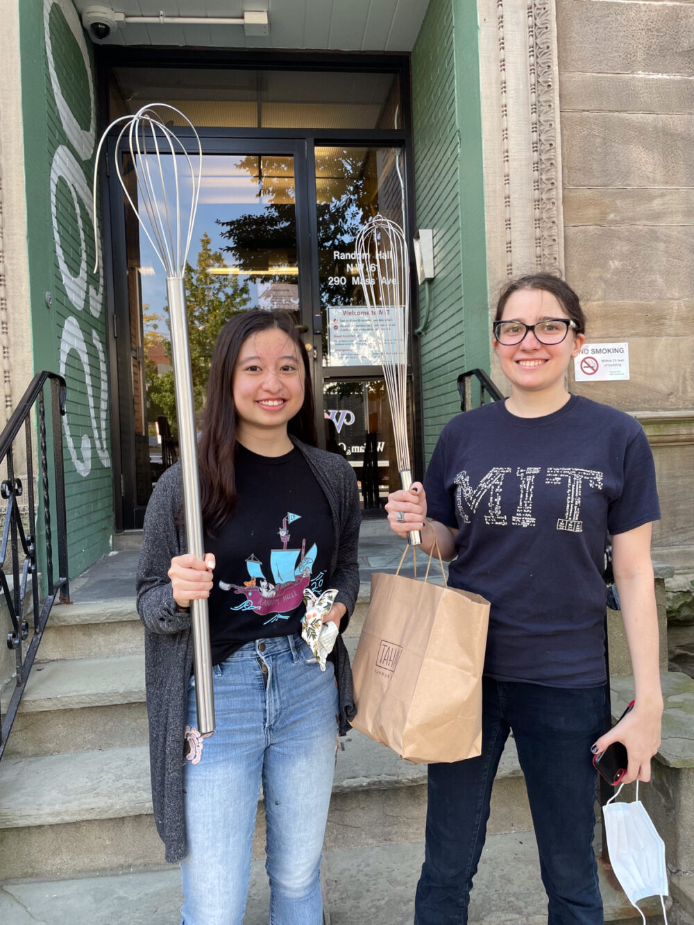 alice and grace holding comically oversized whisks