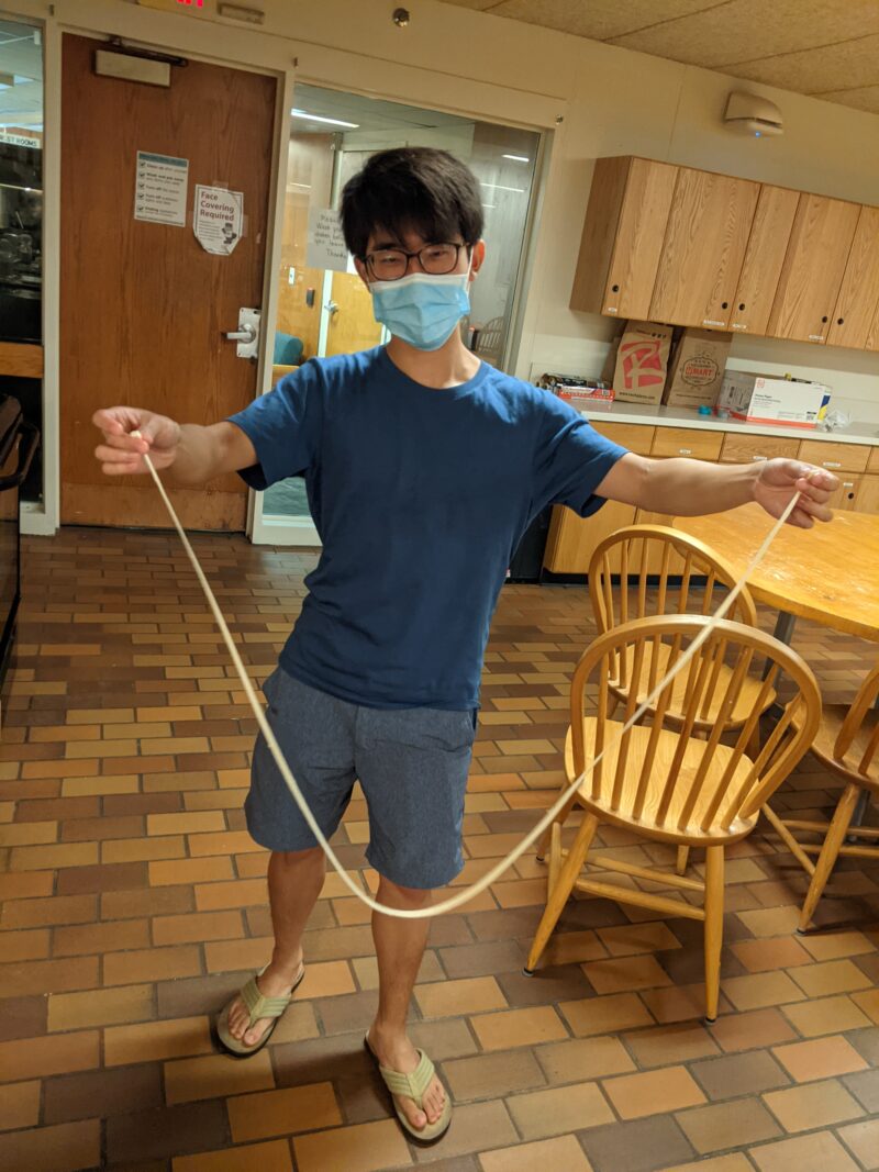 a friend pulls a very long noodle