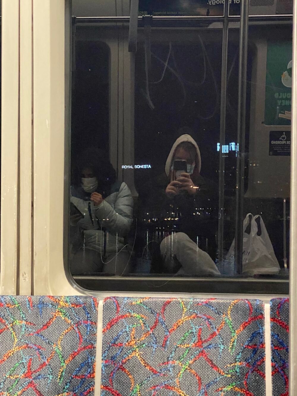 mirror selfie in subway car window