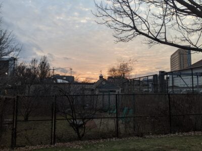 sun setting over a shed