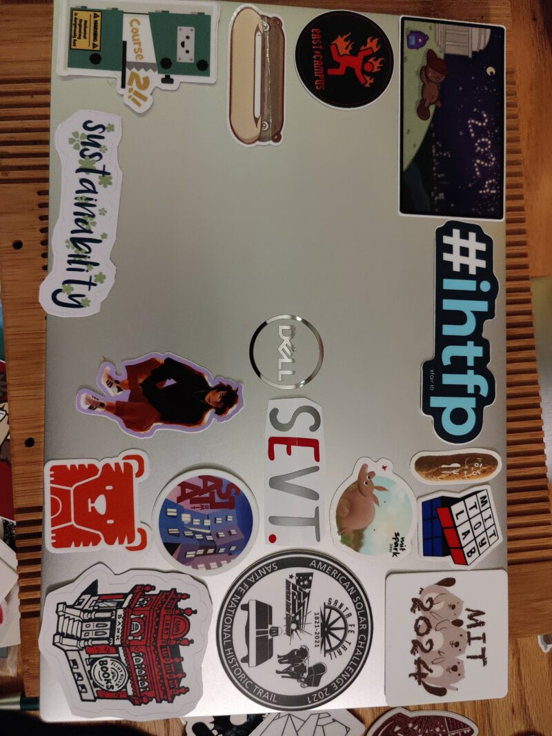 laptop with stickers on it