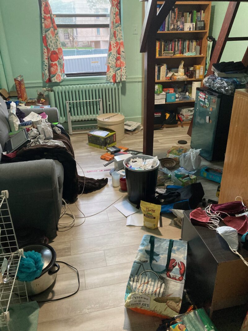 My room. It's very messy: the couch and the floor are both covered in random stuff.