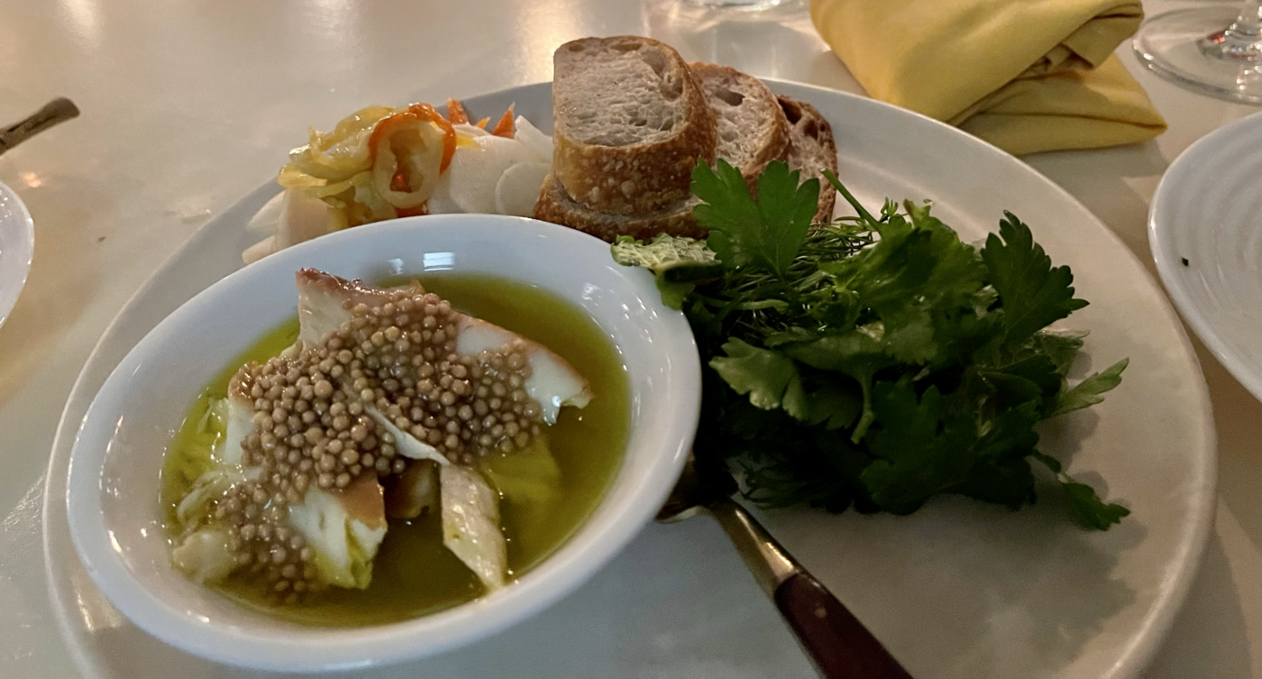fish, bread, herbs, pickled veggies on plate