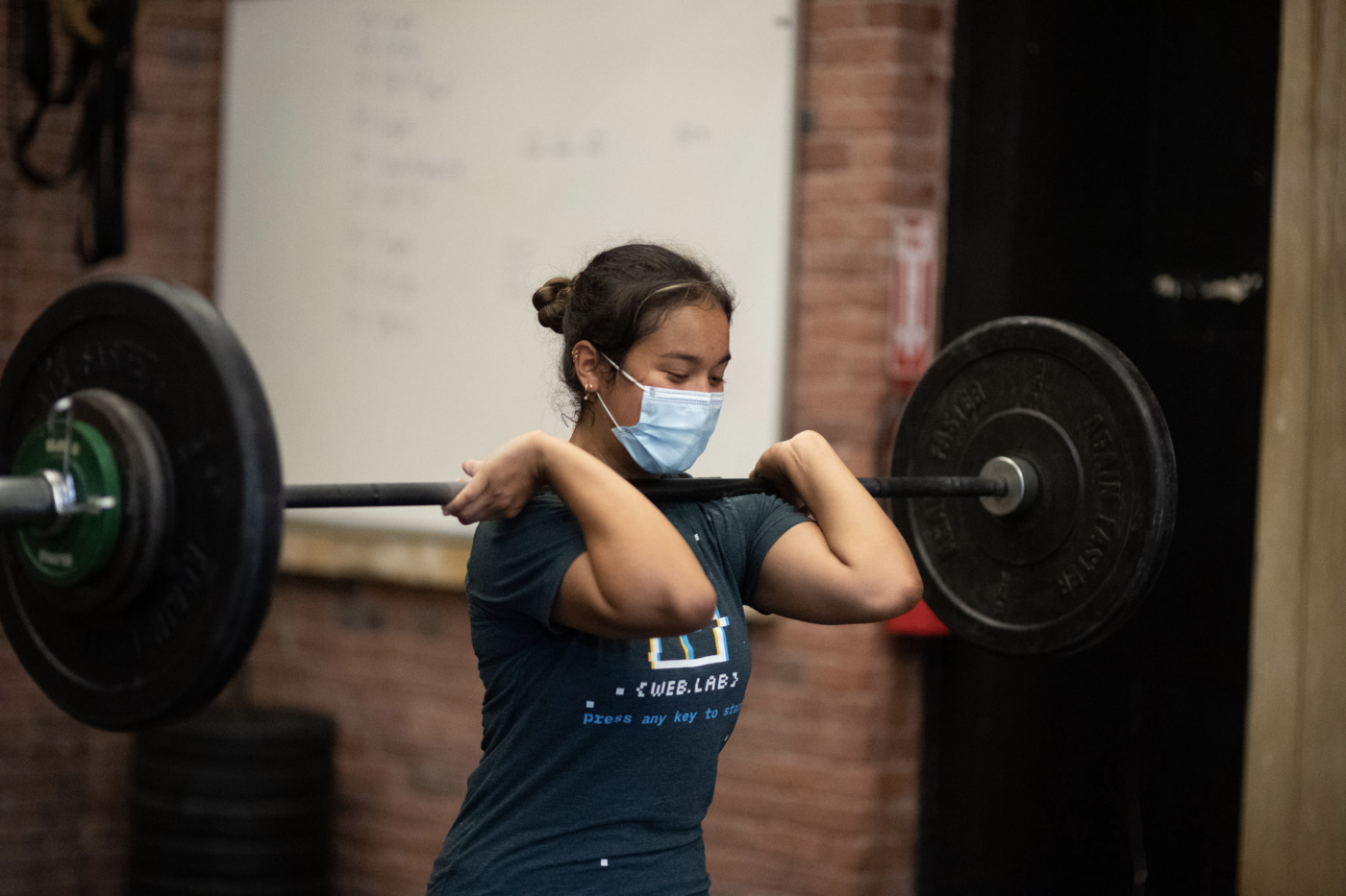person lifting barbell