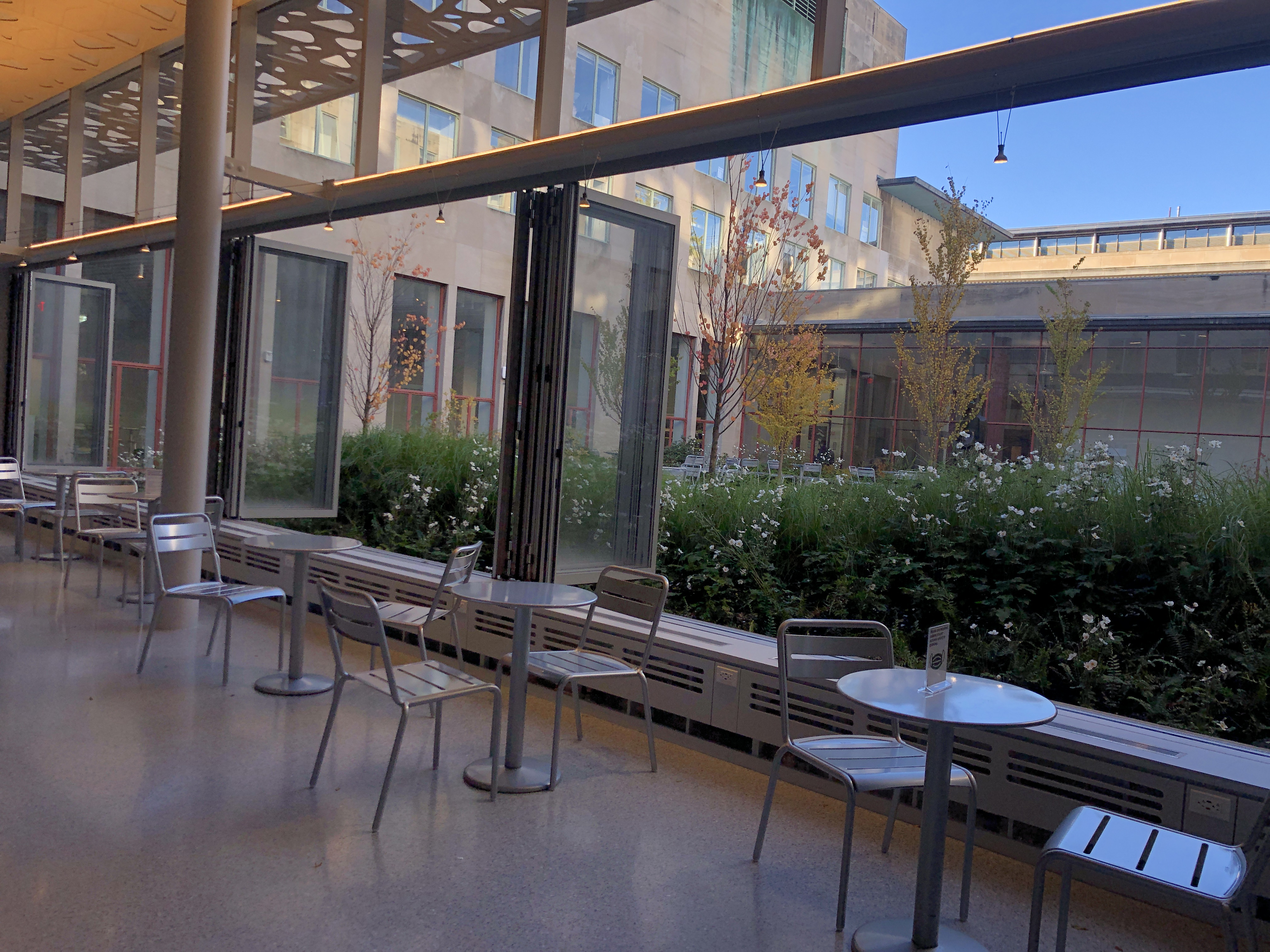 tables and windows opening into a courtyard