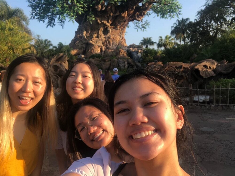 4 female college students in front of disney world animal park tree