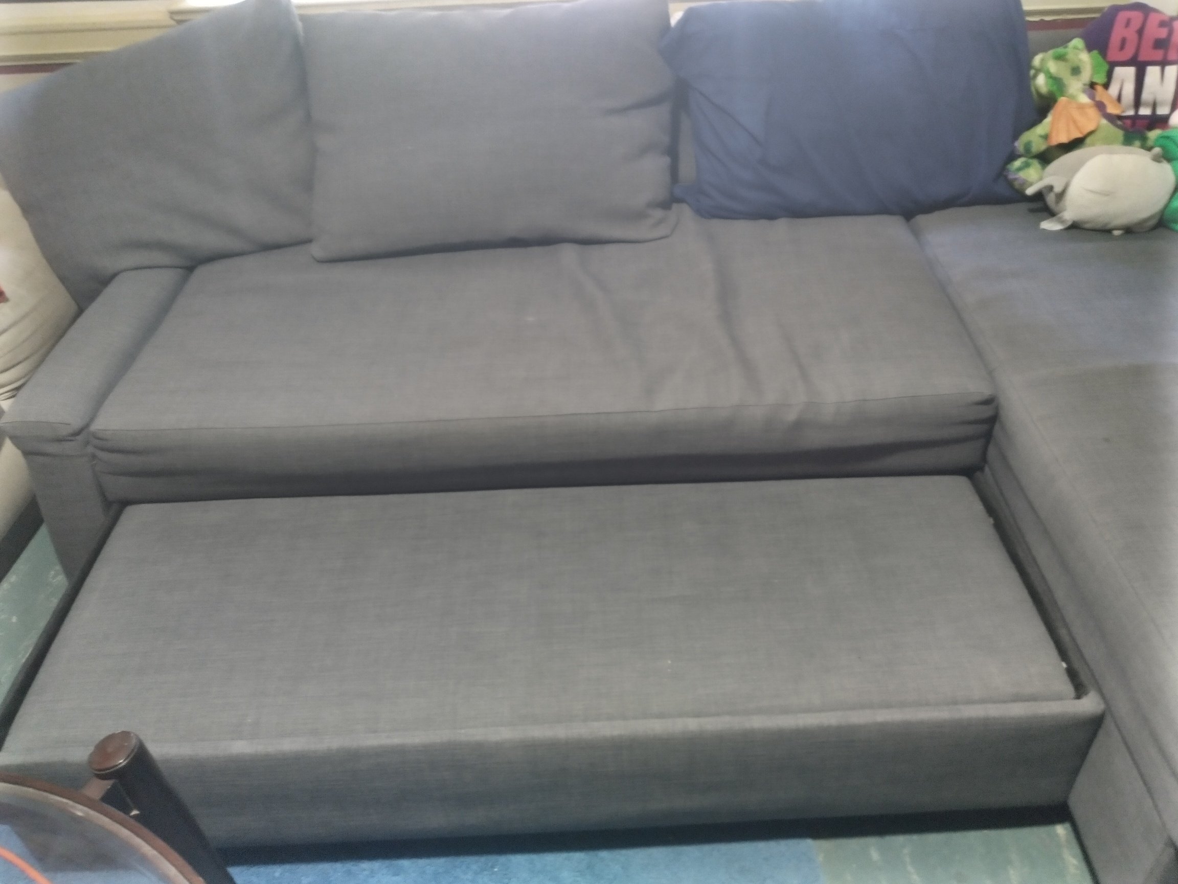 the gray couch with the bottom extended