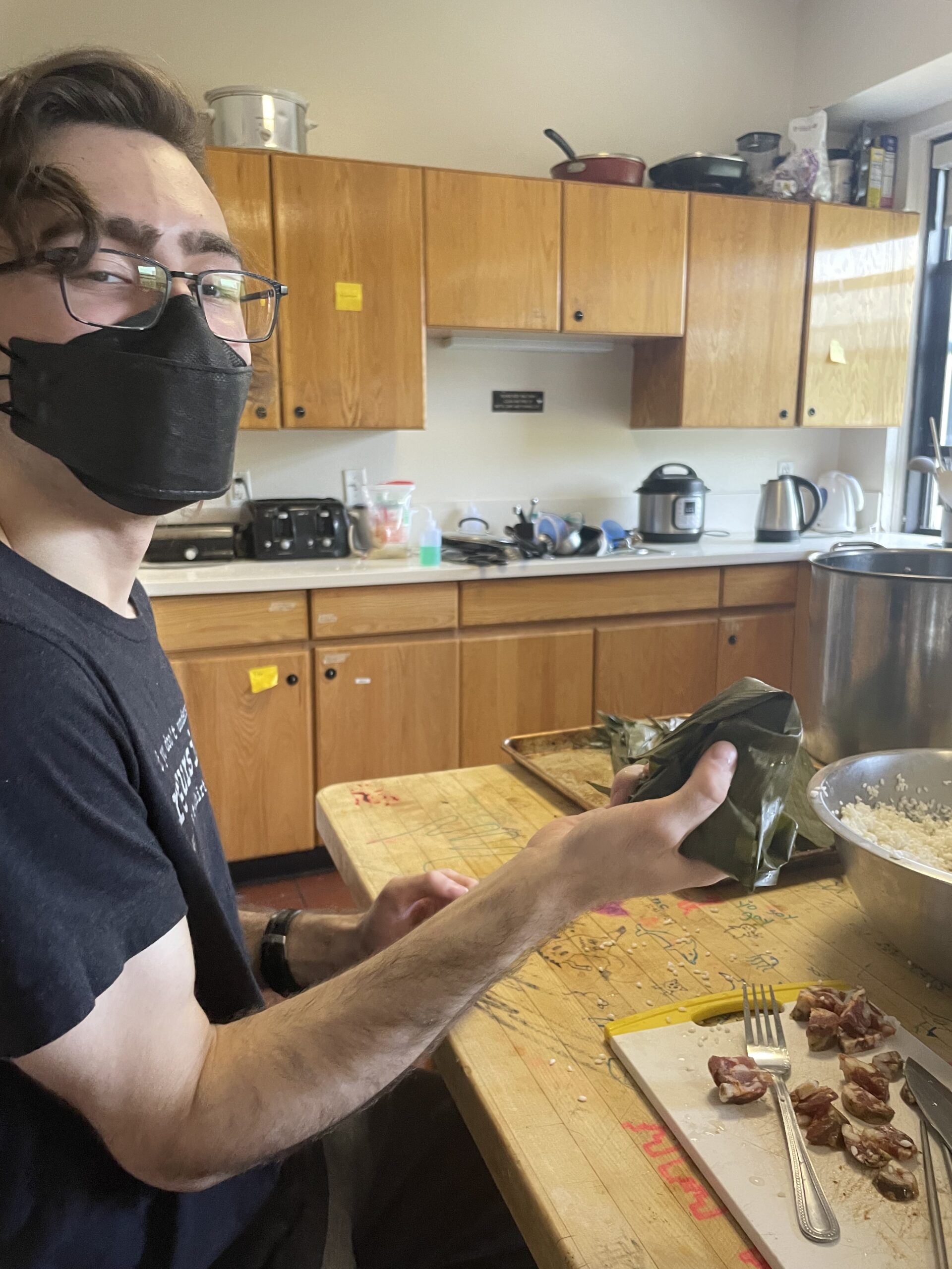 Dylan holds a topologically questionable and definitely structurally unstable zongzi.