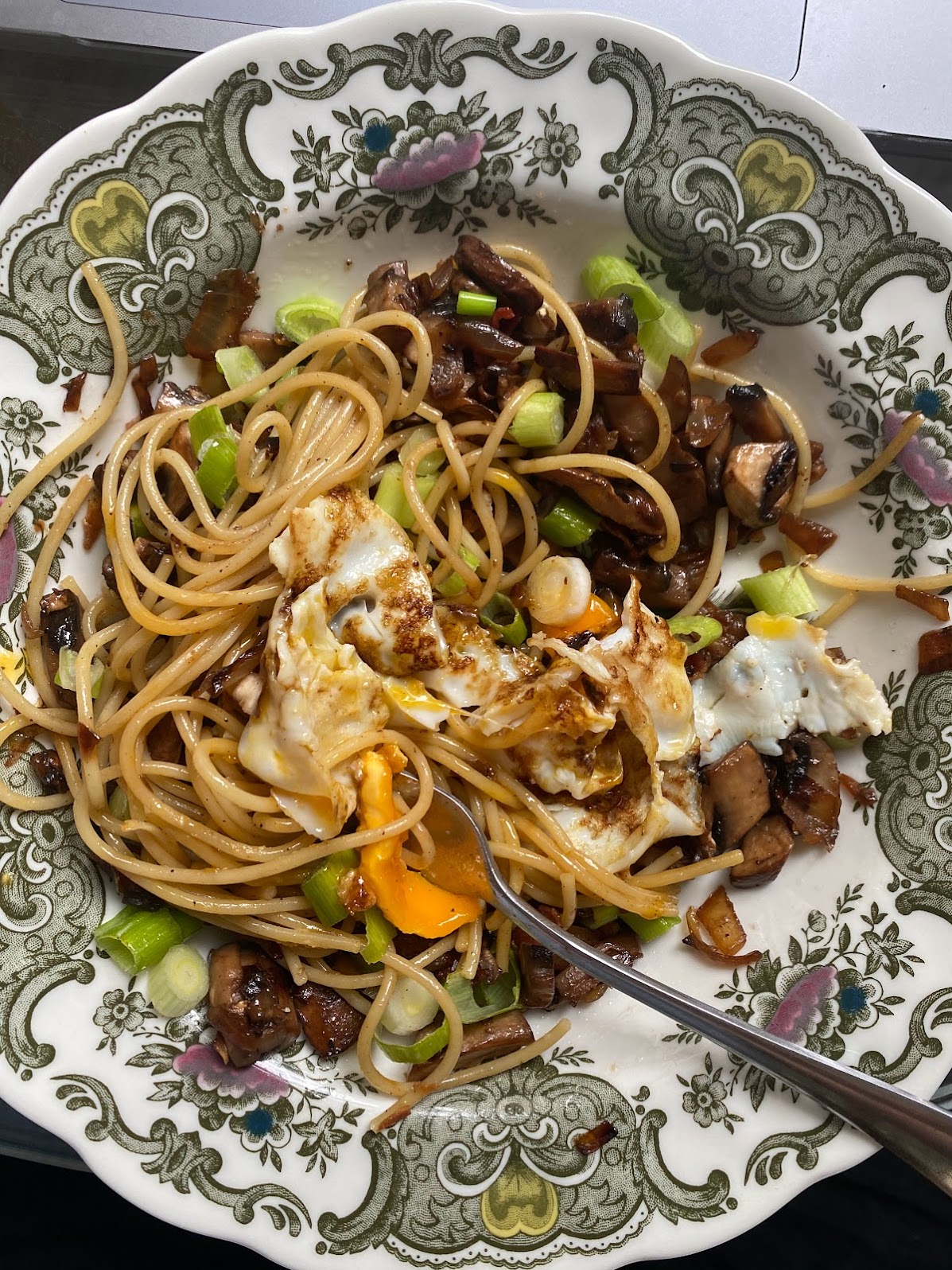 plate with spaghetti, mushrooms, and greens