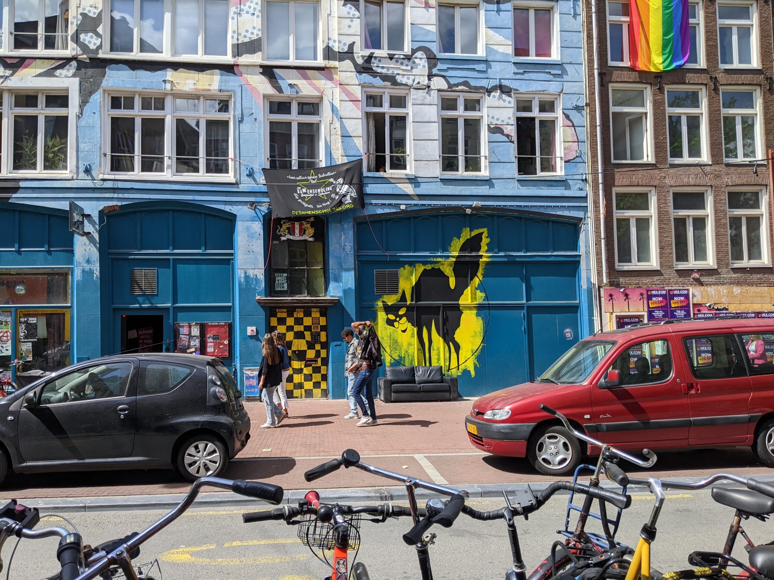 bikes and a mural of a black cat