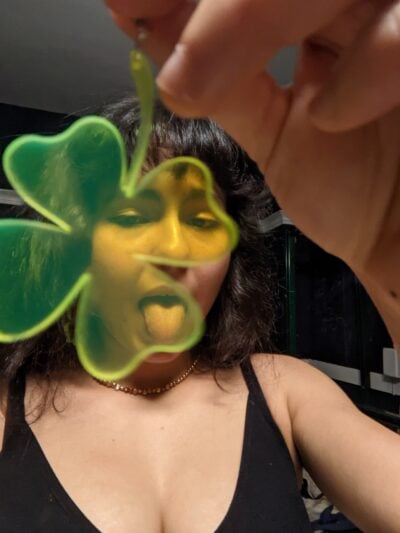 me holding up a 4-leaf clover earring
