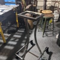 forge stand -- like a narrow coffee table but made of metal
