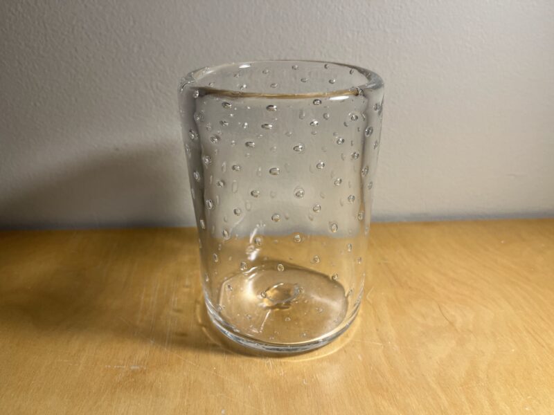 A glass cup with bubbles