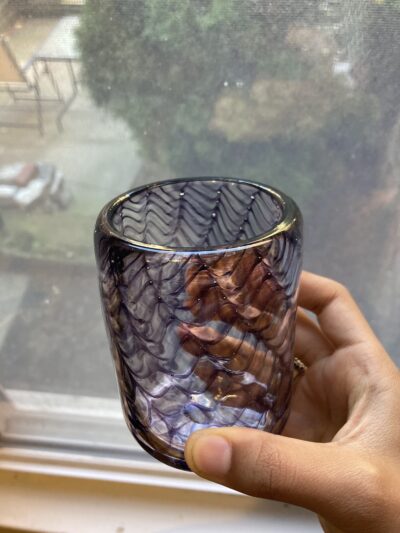 A clear cup with purple netting-like lines.