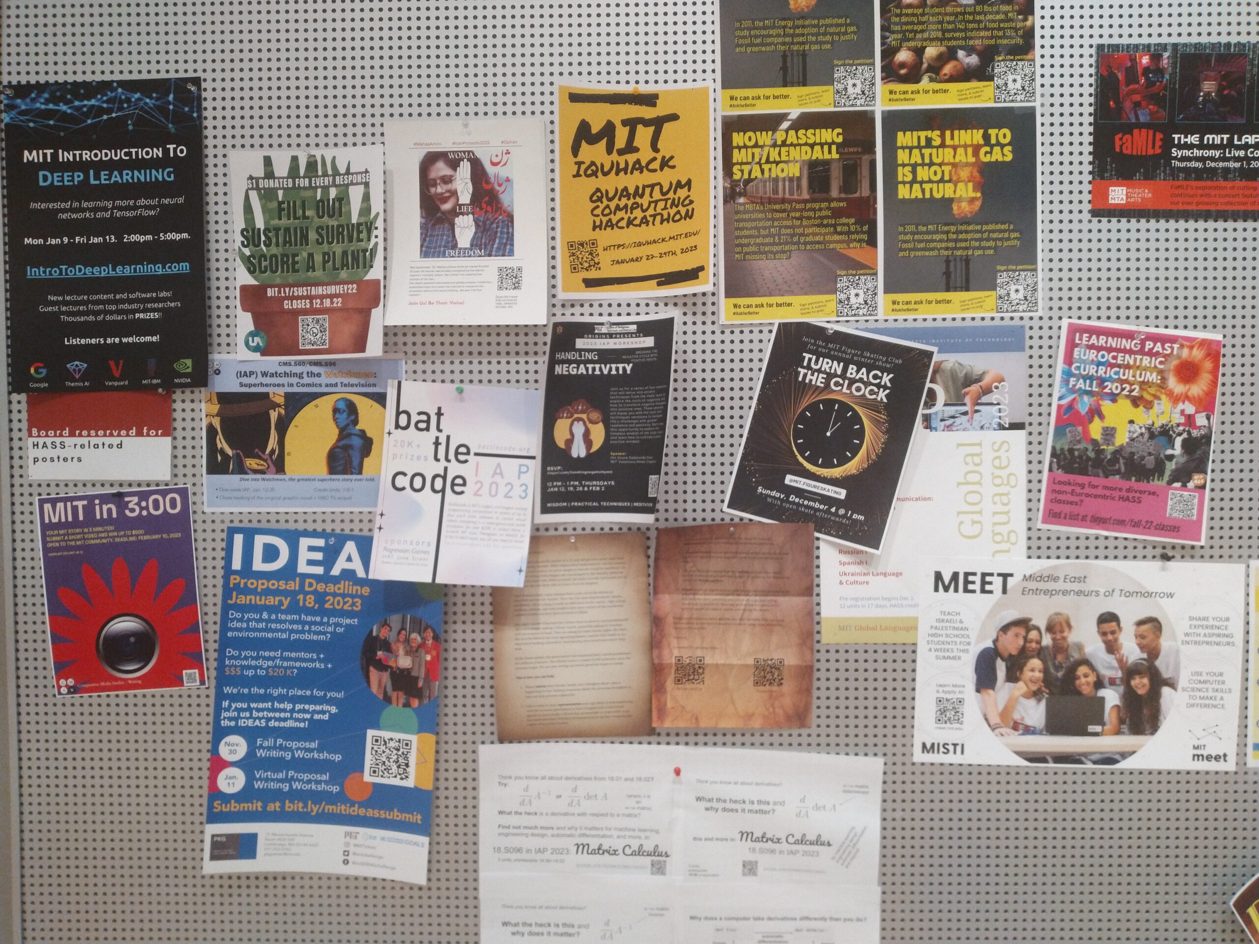 bulletin board with dozens of posters