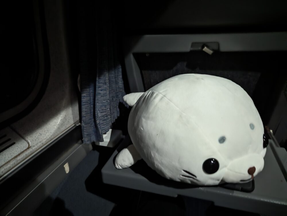 a seal plushie on a tray table