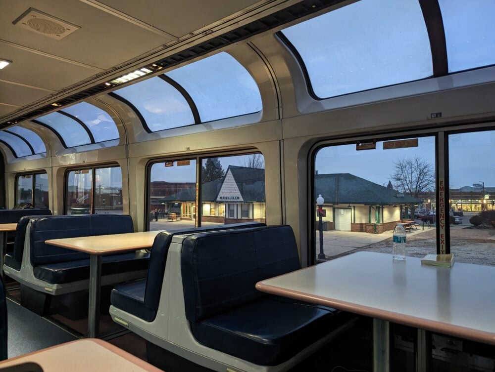 booth tables with train station outside window