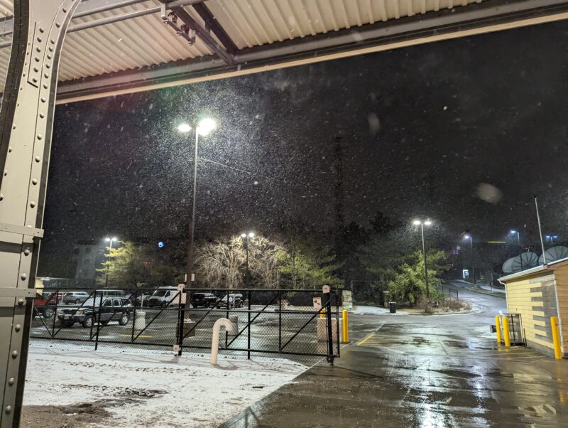 snow blowing into a camera looking out under a train platform