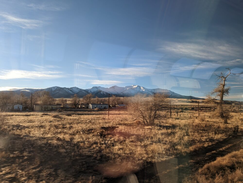 snowy mountains peeking out above grassy plains