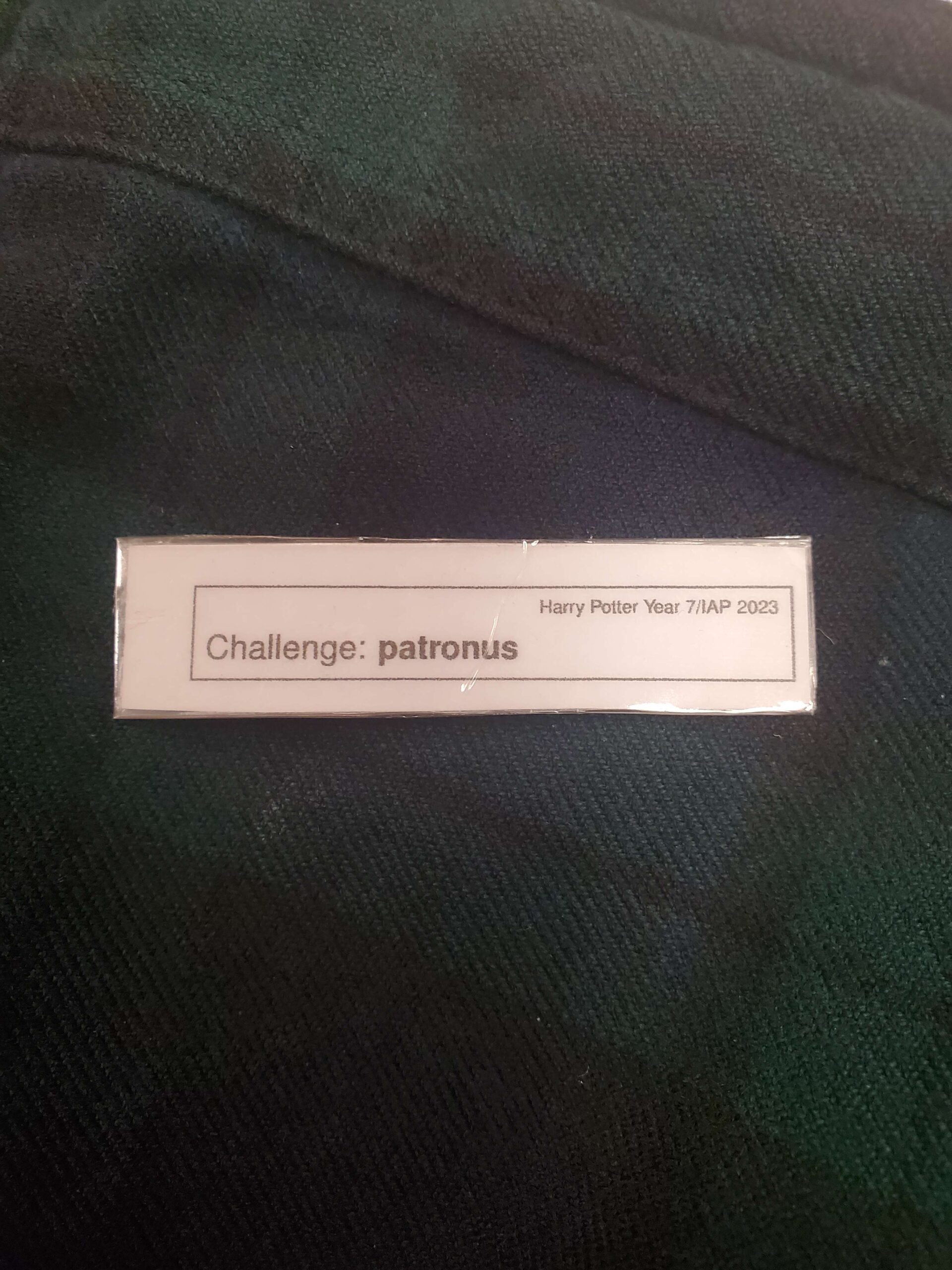 a small strip of paper saying "Challenge: patronus"