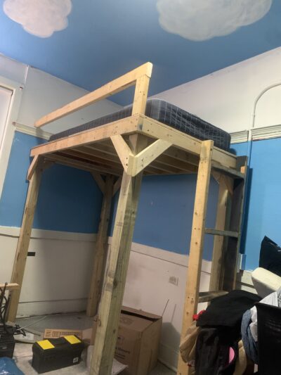 lofted bed that I built with deep teal bedding