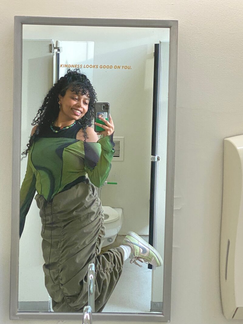 black woman with green top and skirt