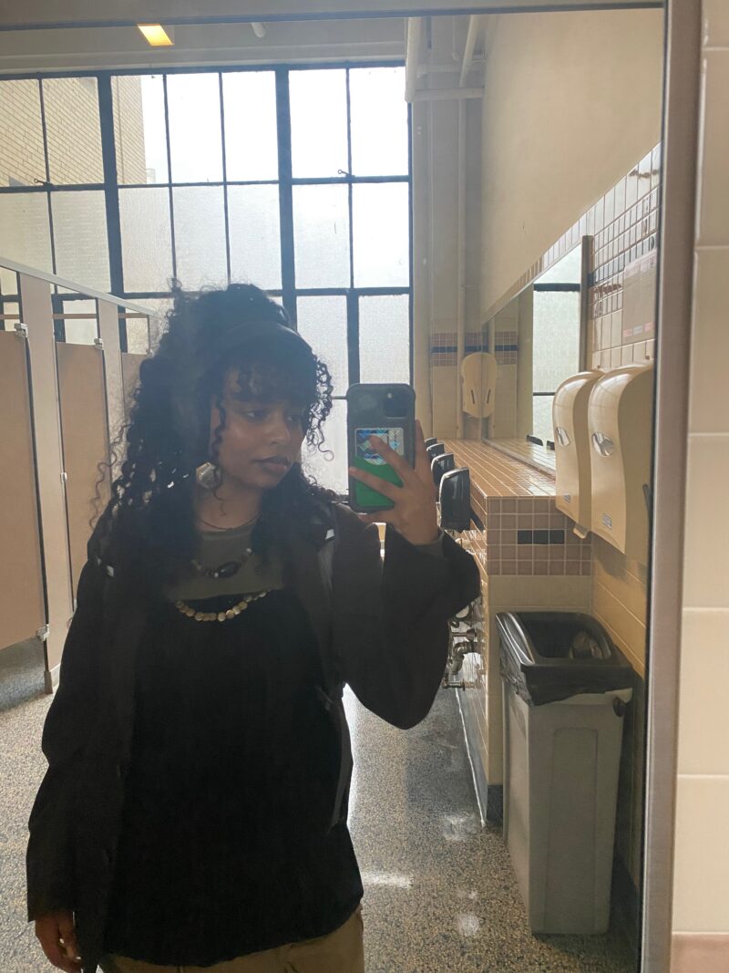 black woman with brown blazer and black top