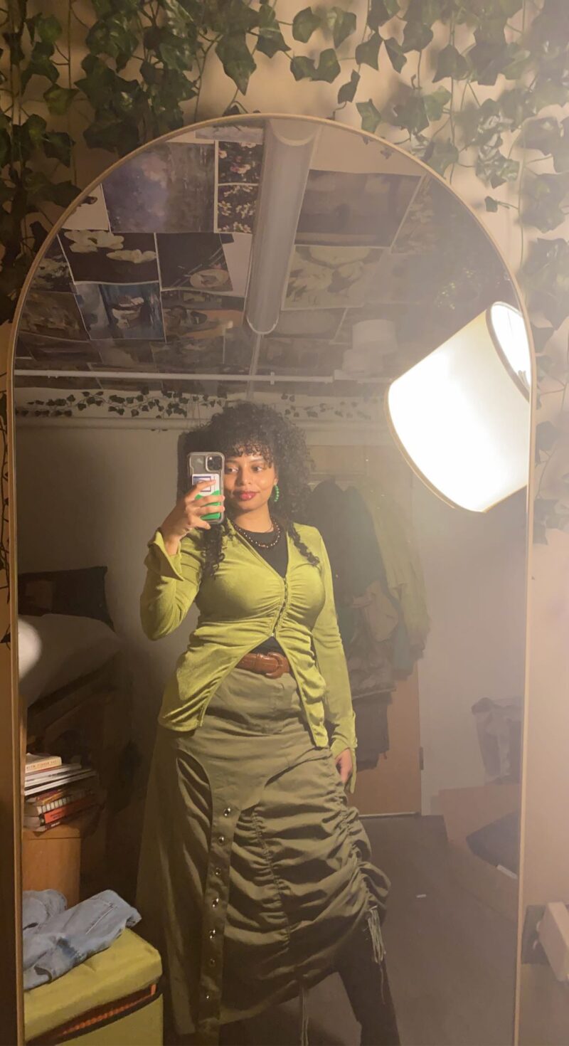 black woman wearing green skirt and top