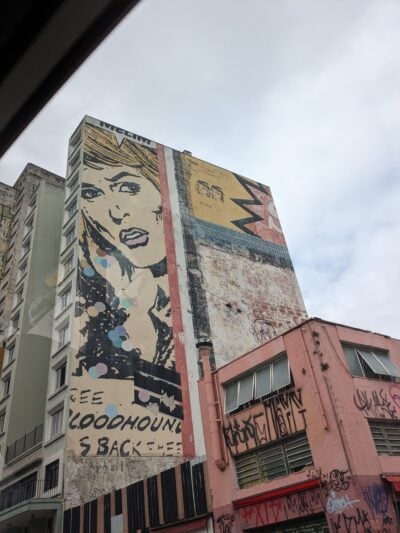mural on a skyscraper of a comic book style woman