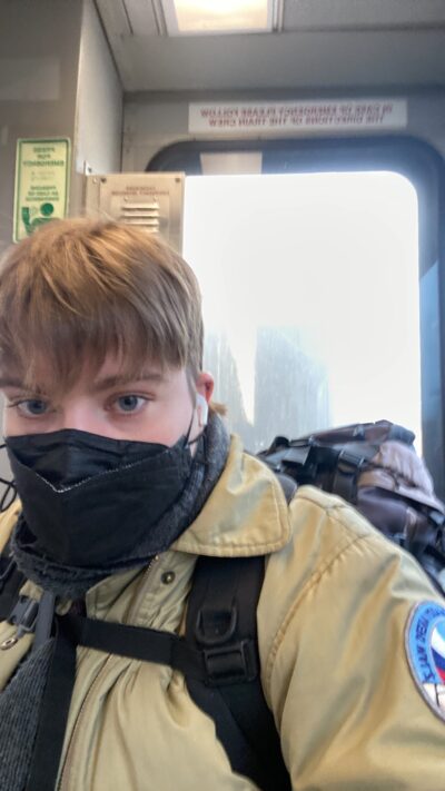 selfie of person in a train with hiking backpack