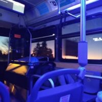a bus, with the sunrise visible outside the window