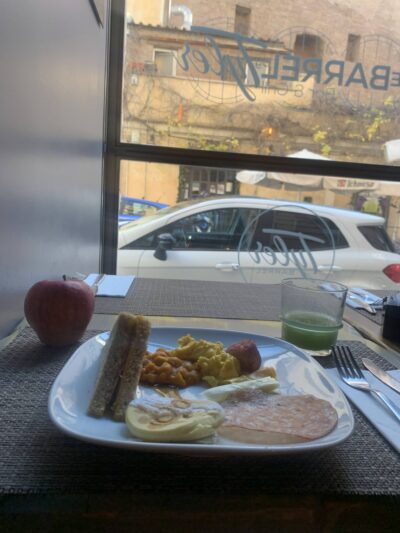 a plate of breakfast with a window side view