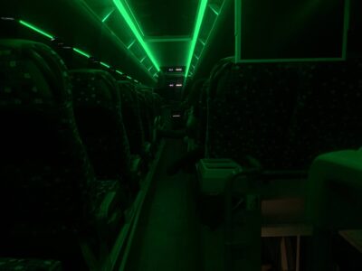 interior of a dark bus with some green lighting