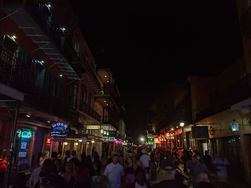 bourbon street at night time with lights and people