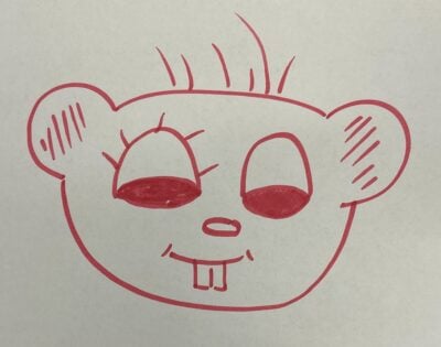 A Tim beaver head drawn in red marker with eyelashes on only one eye and hairs sticking out of the top of its head. The pupils are giant.