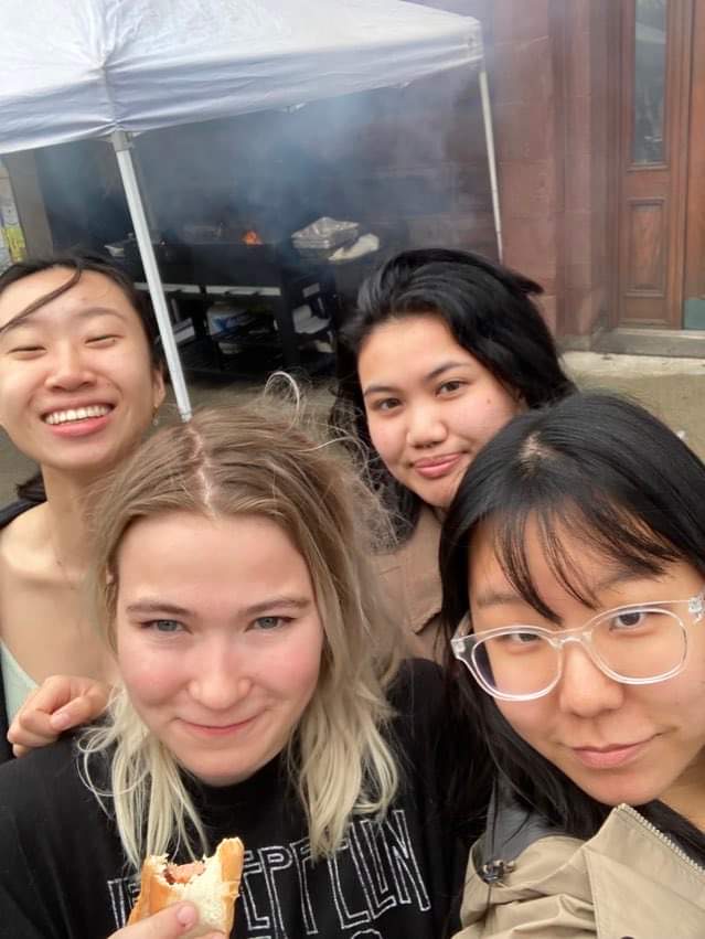 girls smiling at camera with food