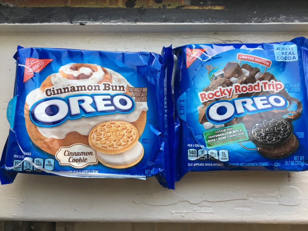 Two unopened oreo packages: "cinnamon bun" on the left and "rocky road" on the right.