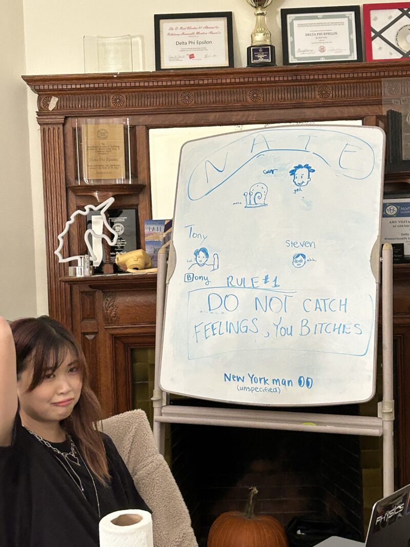 girl looking sad in front of a whiteboard that says