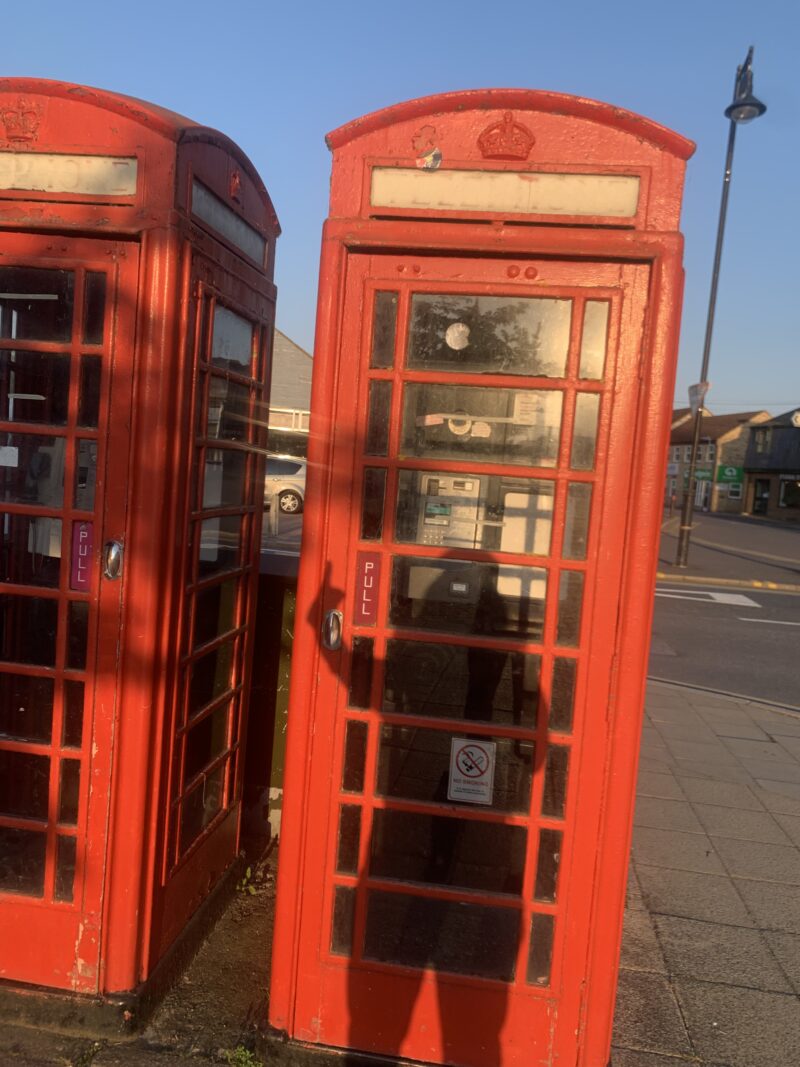 me giving a thumbs up in front of a British phone booth