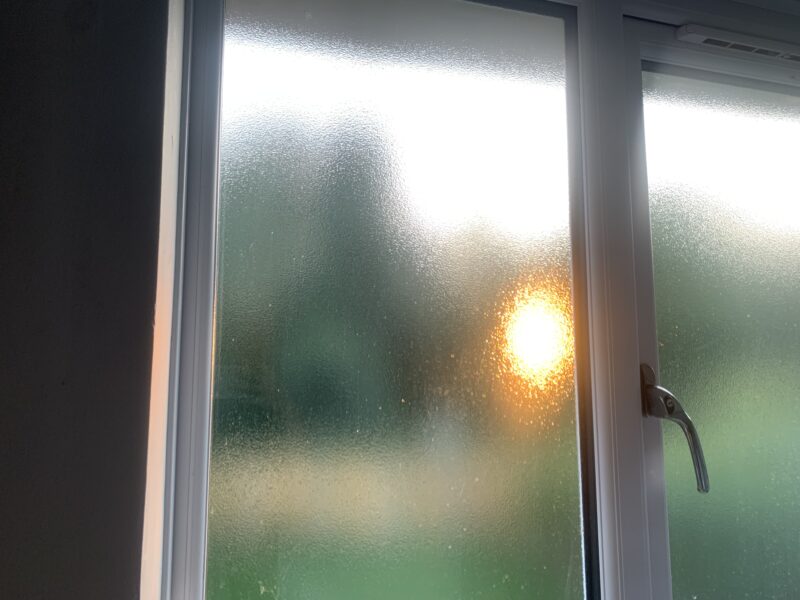 sun shining behind a frosted window