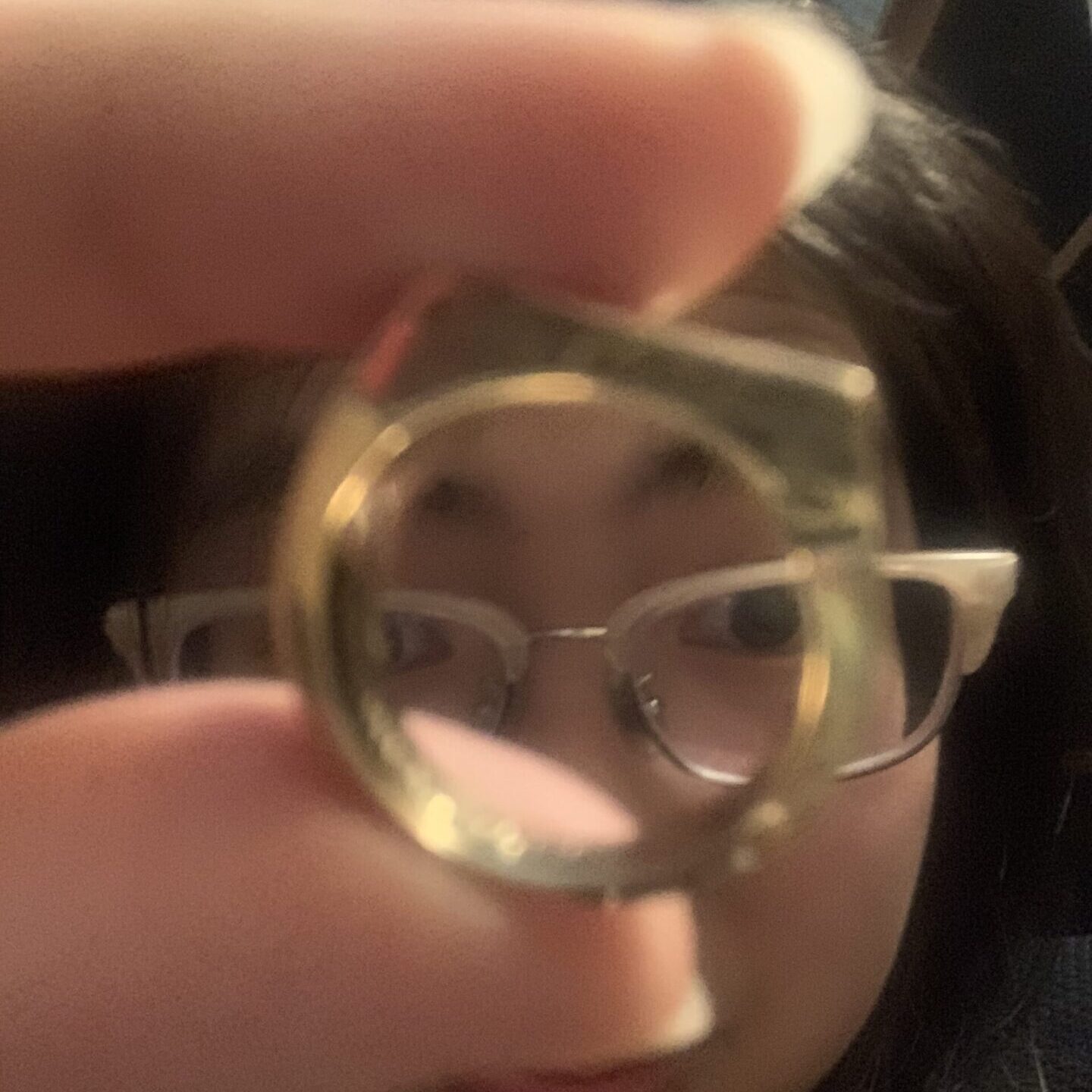 woman holding gold ring