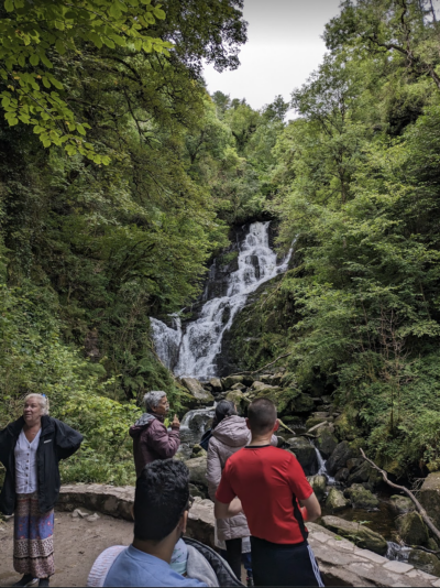 water fall with people in front