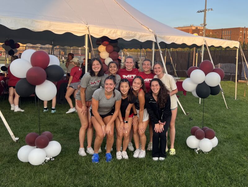 Field hockey team posing together.