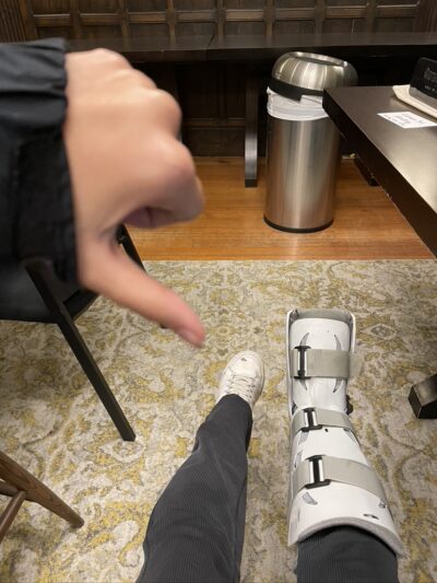 Medical boot on one foot, normal shoe on the other.