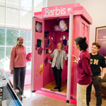 Interphase EDGE/x participants stand beside the Barbie-themed TARDIS with MIT President Sally Kornbluth