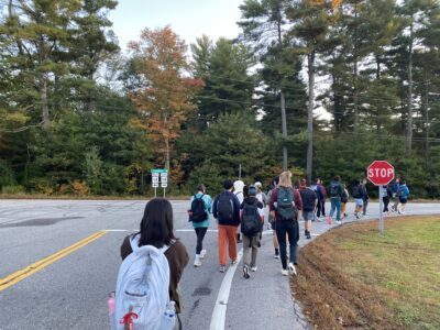 us walking by a road