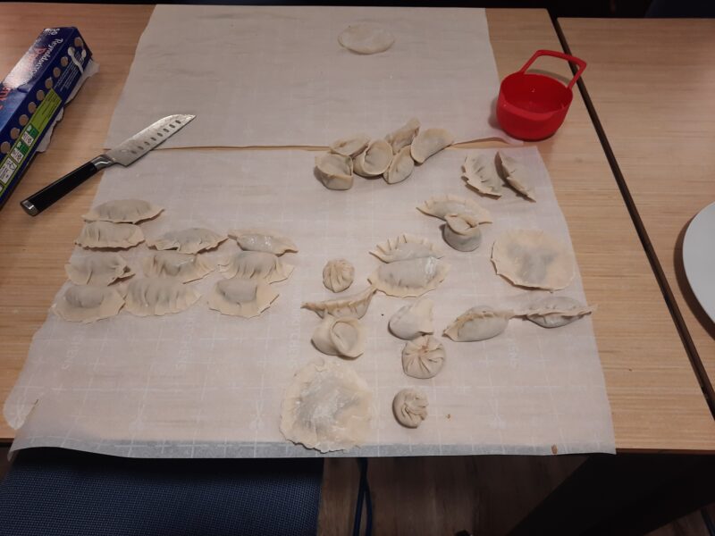 Folded dumplings on parchment paper