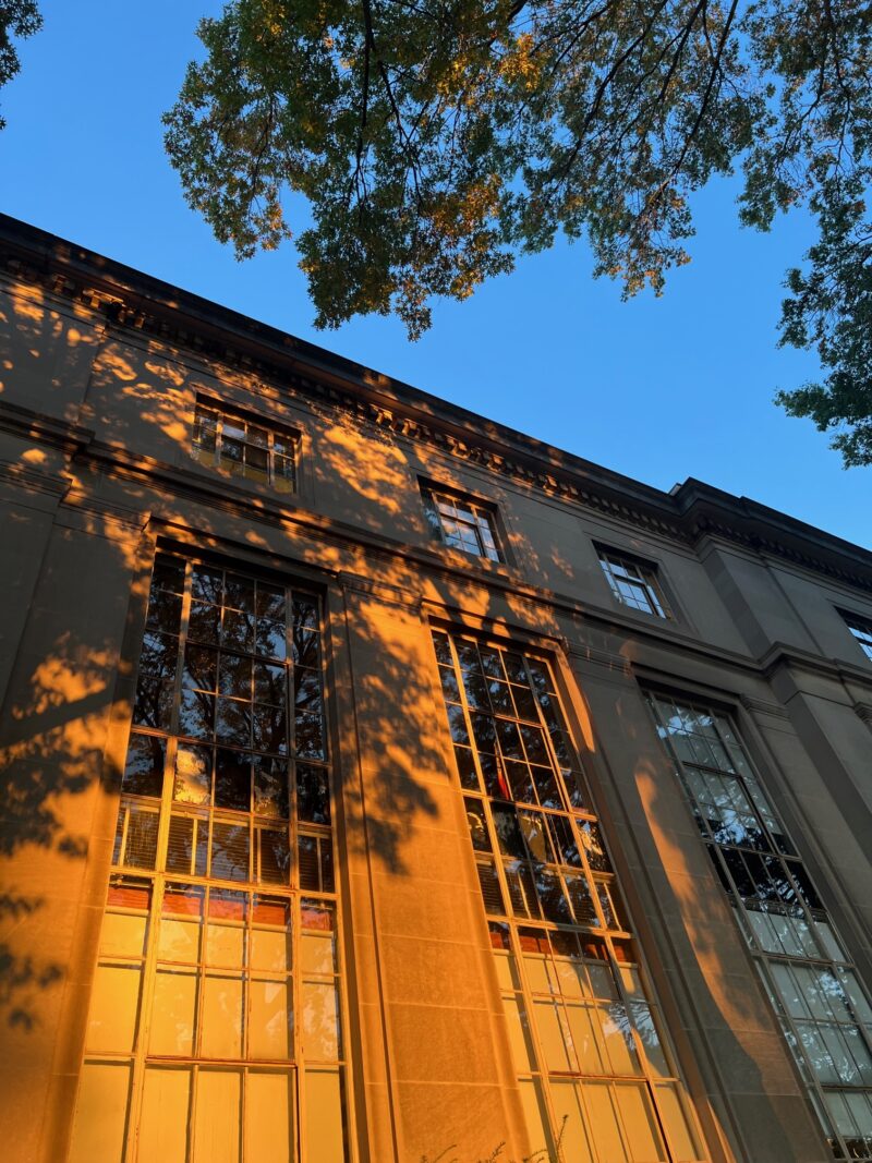 golden hour casting orange light on the side of building 3 at MIT